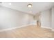 A bright room featuring hardwood floors, neutral walls, and recessed lighting, ideal for modern living at 1513 Landis Ave, Charlotte, NC 28205