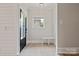 Bright entryway with wood floors, bench seating, and shiplap accent wall at 1513 Landis Ave, Charlotte, NC 28205