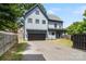 Charming two-story home featuring a modern gray exterior, a two-car garage, and a well-manicured front lawn at 1513 Landis Ave, Charlotte, NC 28205