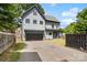Charming two-story home featuring a modern gray exterior, a two-car garage, and a well-manicured front lawn at 1513 Landis Ave, Charlotte, NC 28205
