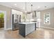 Modern kitchen featuring stainless steel appliances, island with pendant lighting, and light countertops at 1513 Landis Ave, Charlotte, NC 28205