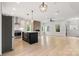 Spacious open-concept kitchen with stainless appliances, island, and fireplace at 1513 Landis Ave, Charlotte, NC 28205