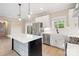 Modern kitchen featuring stainless steel appliances, island with pendant lighting, and light countertops at 1513 Landis Ave, Charlotte, NC 28205