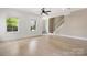 Open-concept living room featuring shiplap walls, wood floors, and staircase at 1513 Landis Ave, Charlotte, NC 28205