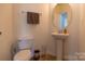 Half bathroom has a pedestal sink, toilet, and a neutral color palette at 159 Saye Pl, Mooresville, NC 28115