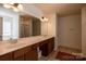 A bright, roomy bathroom featuring a double sink vanity, large mirrors and a walk-in shower at 159 Saye Pl, Mooresville, NC 28115