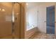 Bathroom with a walk in shower, soaking tub and a door leading to another room at 159 Saye Pl, Mooresville, NC 28115