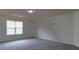 This bright bedroom features neutral walls and plush carpeting, complemented by natural light streaming through the window at 159 Saye Pl, Mooresville, NC 28115