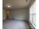 This bedroom has an entrance into another room of the house and a large window at 159 Saye Pl, Mooresville, NC 28115