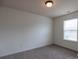 Carpeted bedroom with a window with a blinds and plain walls at 159 Saye Pl, Mooresville, NC 28115
