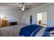 Bright bedroom with a large bed, ceiling fan, and adjacent bathroom and closet at 159 Saye Pl, Mooresville, NC 28115