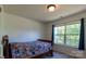 Bedroom with a colorful comforter, window and neutral carpet at 159 Saye Pl, Mooresville, NC 28115