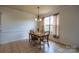 Dining room featuring tile floors, a wooden table with chairs, a chandelier and a window at 159 Saye Pl, Mooresville, NC 28115