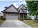 Charming two-story home featuring a brick and siding facade, attached two car garage, and well manicured landscaping at 159 Saye Pl, Mooresville, NC 28115