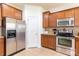 Bright kitchen with stainless steel appliances, shaker cabinets, neutral granite counters, tile backsplash and flooring at 159 Saye Pl, Mooresville, NC 28115
