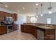 Open kitchen showcasing tile floors, stainless steel appliances, breakfast bar and granite countertops at 159 Saye Pl, Mooresville, NC 28115