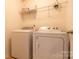 Modern laundry room with a washer, dryer, and ample shelving at 159 Saye Pl, Mooresville, NC 28115