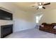 Living room featuring neutral carpet, fire place, mounted television and comfortable seating area at 159 Saye Pl, Mooresville, NC 28115