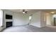 Living room features neutral paint, a fireplace, large windows, and a ceiling fan at 159 Saye Pl, Mooresville, NC 28115
