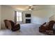Cozy living room with a fireplace, mounted tv, neutral carpet, and comfortable seating at 159 Saye Pl, Mooresville, NC 28115