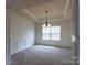 The spacious, carpeted living room features large windows and a chandelier at 159 Saye Pl, Mooresville, NC 28115