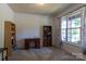 Bright office space with a large window, bookshelf, and neutral tones that create a productive environment at 159 Saye Pl, Mooresville, NC 28115