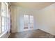 Bright home office with carpeted floors, French doors, and a window, ideal for remote work at 159 Saye Pl, Mooresville, NC 28115