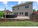 Expansive backyard featuring a large patio, outdoor seating, manicured lawn, and string lights at 16114 Foreleigh Rd, Huntersville, NC 28078