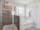 Clean bathroom with a glass-enclosed shower and soaking tub at 16114 Foreleigh Rd, Huntersville, NC 28078