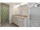 Bathroom featuring a double sink vanity with granite counters and access to the shower at 16114 Foreleigh Rd, Huntersville, NC 28078