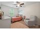 Bright bedroom with a soft color scheme, chair, and natural light from the window at 16114 Foreleigh Rd, Huntersville, NC 28078