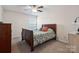 Bedroom with hardwood floors, ceiling fan, and natural light from the window at 16114 Foreleigh Rd, Huntersville, NC 28078