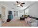 Large bonus room with a ceiling fan, comfortable seating and a view of French doors at 16114 Foreleigh Rd, Huntersville, NC 28078