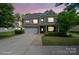 Charming two-story home featuring a brick and siding exterior, well-maintained landscaping, and a two-car garage at 16114 Foreleigh Rd, Huntersville, NC 28078