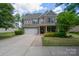 Charming two-story home featuring a brick and siding exterior, well-maintained landscaping, and a two-car garage at 16114 Foreleigh Rd, Huntersville, NC 28078