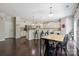 Spacious kitchen and dining area with dark hardwood floors and white cabinets, perfect for Gathering gatherings at 16114 Foreleigh Rd, Huntersville, NC 28078