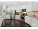 Bright kitchen with stainless steel appliances, granite countertops, and white cabinetry for a modern feel at 16114 Foreleigh Rd, Huntersville, NC 28078