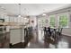 Bright and open kitchen featuring white cabinets, granite countertops, stainless steel appliances, and a dining area at 16114 Foreleigh Rd, Huntersville, NC 28078