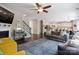 Cozy living room with hardwood floors, a fireplace, and an open layout leading to the kitchen and dining area at 16114 Foreleigh Rd, Huntersville, NC 28078