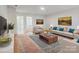 Modern living room with wood floors, stylish furniture, and decor at 16114 Foreleigh Rd, Huntersville, NC 28078