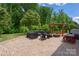 Spacious patio area with outdoor seating, pergola, fire pit, and lush greenery, perfect for entertaining at 16114 Foreleigh Rd, Huntersville, NC 28078