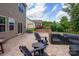 Beautifully designed patio with comfortable seating, lush landscaping, and serene backyard views at 16114 Foreleigh Rd, Huntersville, NC 28078