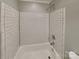 A tub shower combination with white subway tiles, and chrome hardware at 2001 Tyvola Rd, Charlotte, NC 28210
