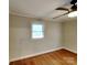 Bedroom with hardwood floors, ceiling fan, and bright window at 2001 Tyvola Rd, Charlotte, NC 28210