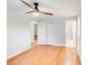 This bedroom features hardwood floors, a ceiling fan, closet, and three doorways at 2001 Tyvola Rd, Charlotte, NC 28210