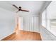 This bedroom boasts hardwood floors, a ceiling fan, closet, and a large window for natural light at 2001 Tyvola Rd, Charlotte, NC 28210