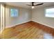 Sunlit bedroom featuring hardwood floors and a modern ceiling fan at 2001 Tyvola Rd, Charlotte, NC 28210
