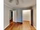This bedroom has hardwood floors, a closet, and door to another room at 2001 Tyvola Rd, Charlotte, NC 28210