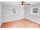 Bright bedroom featuring hardwood floors, two windows for natural light and neutral paint at 2001 Tyvola Rd, Charlotte, NC 28210