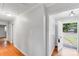 Inviting entryway with hardwood floors, neutral paint, and well lit from the front door to welcome you into the home at 2001 Tyvola Rd, Charlotte, NC 28210